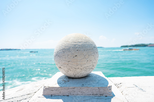 Stone Bridge Balls. Stone balls on bridge parapet on blue Lagoon in Venice  Italy. Architecture detail. Stone Balustrade with decoration balls. Old Authentic Bridge Staircase made of White Granite. 