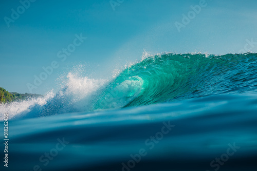 Barrel wave in sea. Blue wave with sun light