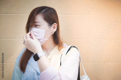 asian woman wear the breathing mask for protect colonavirus and health care from exhaust gases photo