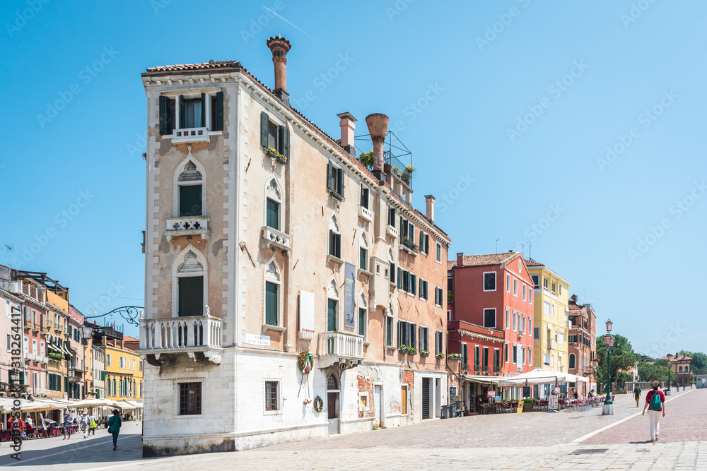 Venice, Italy. Beautiful embankment. Venetian old colorful building palazzo against blue sky. Authentic architecture. Travel Tourism Vacation in Europe concept.