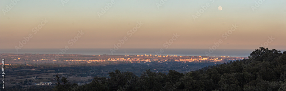 Full moon and Panoramic view of the Roussillon plain and the sea