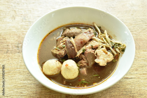 braised pork and ball with bean sprout in brown soup on bowl