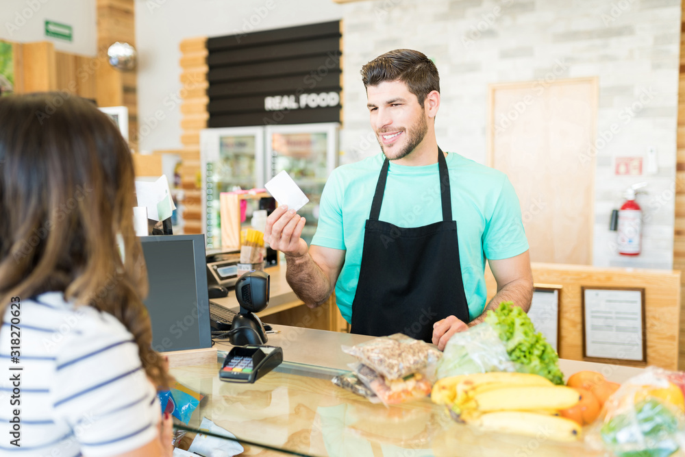 Confident Cashier With Customer In Grocery Store Confident Cashier With Customer In Grocery Store