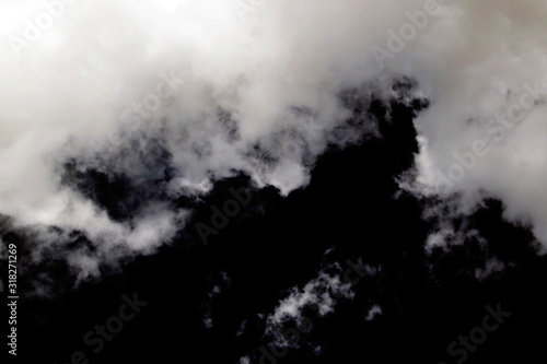 White and gray clouds against the black sky. Cloudy sky background. Cloudy weather.