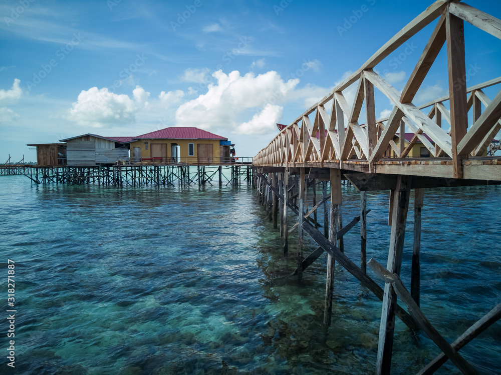scenery of water chalet above the coral reef during low tide in Semporna island. scenery of water chalet above the coral reef during low tide in Semporna island.