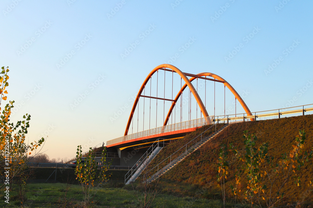 Rzeszow, Poland - 9 9 2018: Suspended road bridge across the autobahn. Metal construction technological structure. Modern architecture Rzeszow, Poland - 9 9 2018: Suspended road bridge across the autobahn. Metal construction technological structure. Modern architecture
