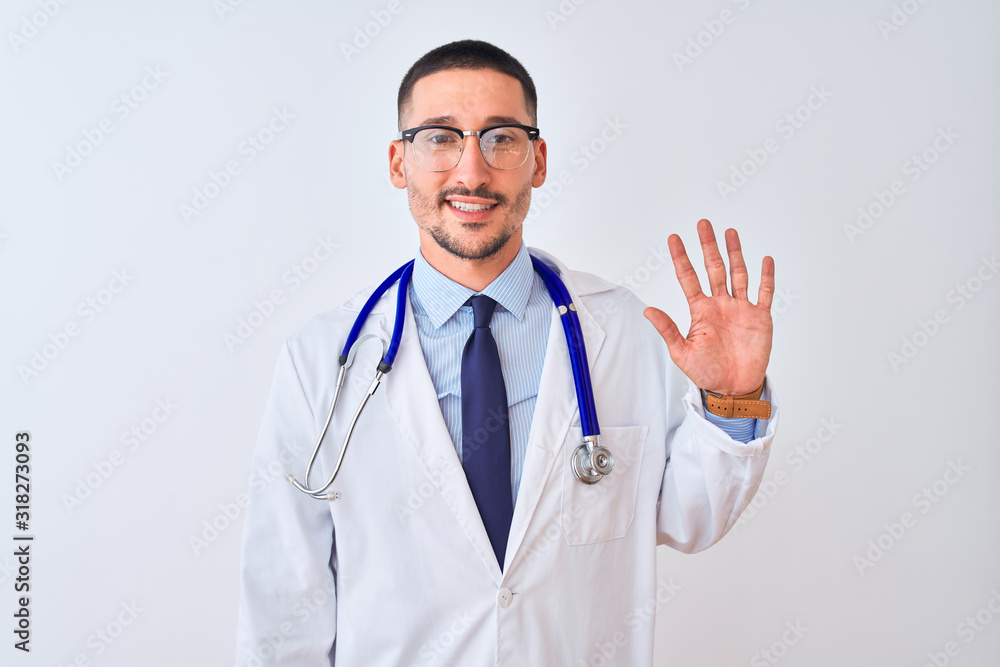 Young doctor man wearing stethoscope over isolated background showing and pointing up with fingers number five while smiling confident and happy. Young doctor man wearing stethoscope over isolated background showing and pointing up with fingers number five while smiling confident and happy.