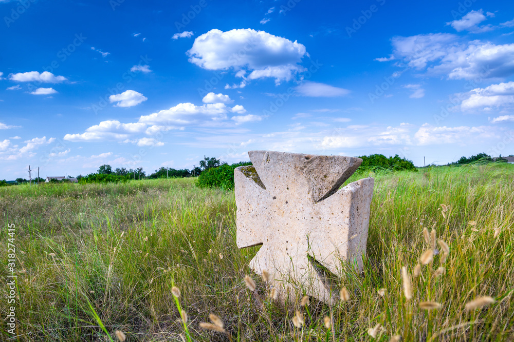 Stone tomb crosses on an ancient Christian necropolis of the 17th-19th centuries. The steppe hills on the right bank of the Dnipro river. Former settlements of Cossacks of Zaporizhzhya Sich in Ukraine