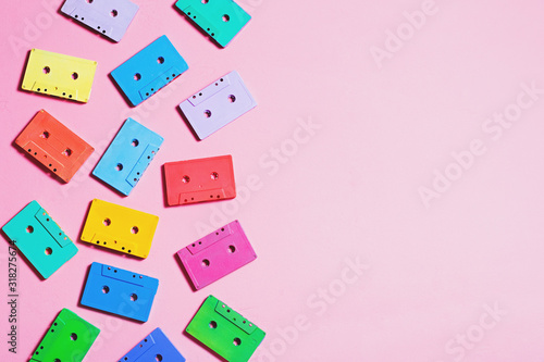 Painted audio cassettes in bright colors on pastel background  copy space  top view. Retro musical background. Retro audio tape cassettes  80s background  pastel retro flat lay