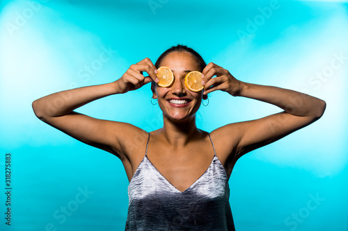 Young Middle Eastern Woman Covering Eyes with Lemon Slices