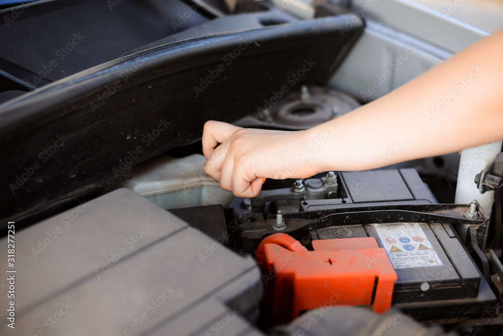 Young girl tries to repair broken car by herself, opening some tank with oil Young girl tries to repair broken car by herself, opening some tank with oil