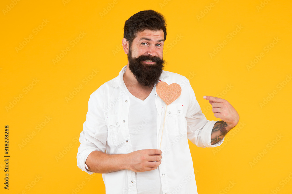 Romantic mood. Handsome macho with long beard. Fall in love. Happy valentines day. Bearded man holding heart. Hipster with small heart. Valentine man with heart shaped card. Expressing his love Romantic mood. Handsome macho with long beard. Fall in love. Happy valentines day. Bearded man holding heart. Hipster with small heart. Valentine man with heart shaped card. Expressing his love