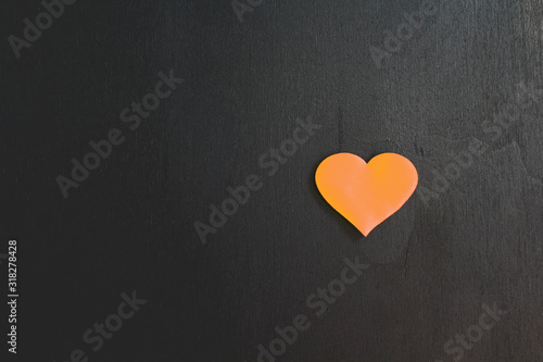 Heart isolated on black background for text