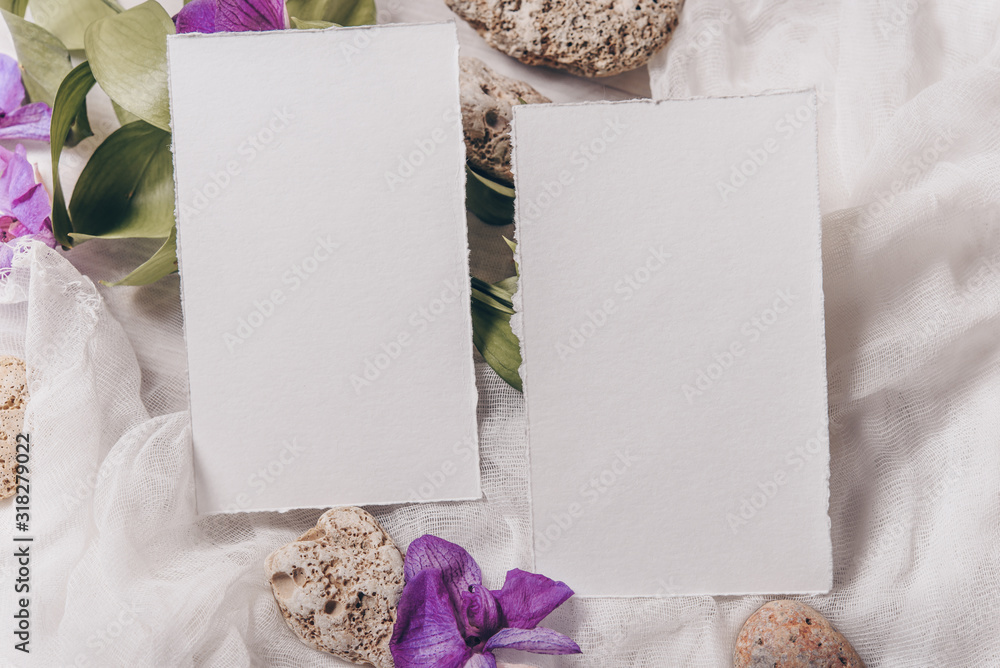 Wedding invitation mockup with paper, stone, green branch on white textile background. Top view, flat lay. Wedding stationary. Perfect for presentation of your wedding invitation, menu, greeting cards Wedding invitation mockup with paper, stone, green branch on white textile background. Top view, flat lay. Wedding stationary. Perfect for presentation of your wedding invitation, menu, greeting cards