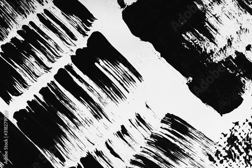 Patterns of black paint from a brush on a white background