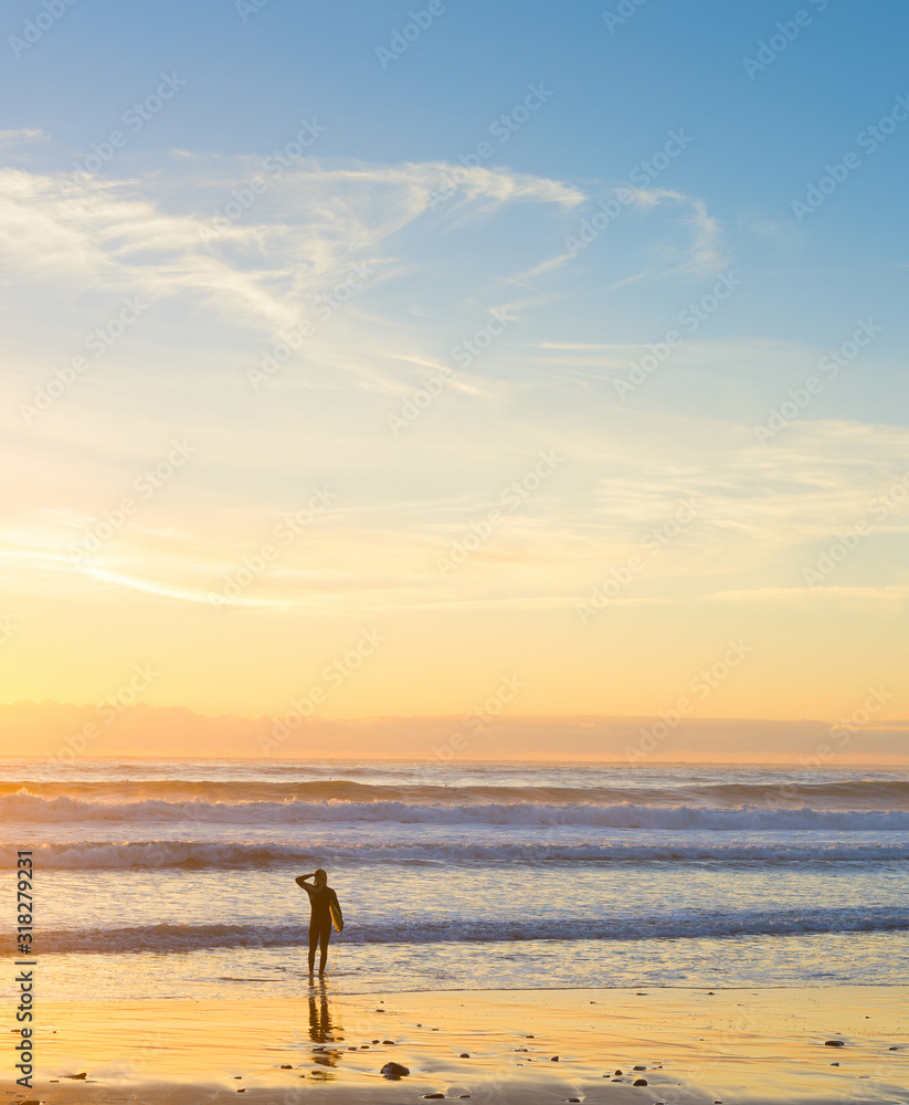 Surfer ocean beach sunset background