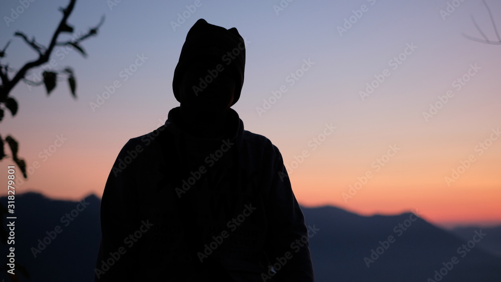 silhouette of man on top of mountain at sunset silhouette of man on top of mountain at sunset
