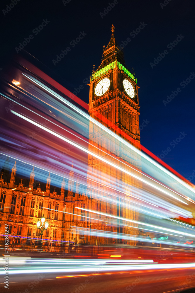 Light trails left by double decker bus passing by Big Ben in London England United Kingdom UK