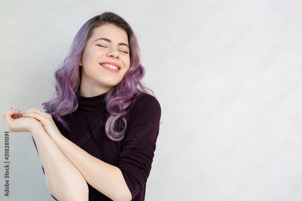 Cheerful young woman over a grey background Cheerful young woman over a grey background