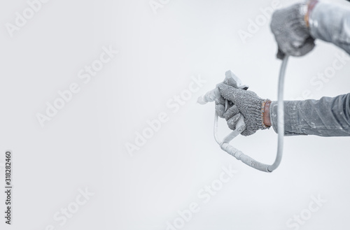 Quadro su tela Airless Spray Painting, Worker painting on steel wall surface by airless spray gun for protection rust and corrosion