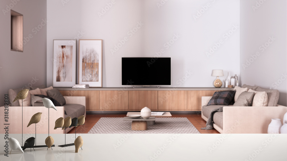 Obraz premium White table top or shelf with minimalistic bird ornament, birdie knick - knack over blurred cosy gray and beige living room with sofa, lounge, carpet, modern interior design