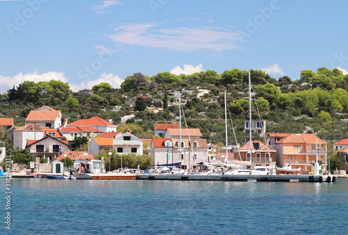 Panorama of a yacht marina in the town of Jezera in Croatia in the Dalmatia region. The ships moored in the port of a quiet fishing town in a sunny, clear day. Tourist marine business. Murter island © Xato Lux