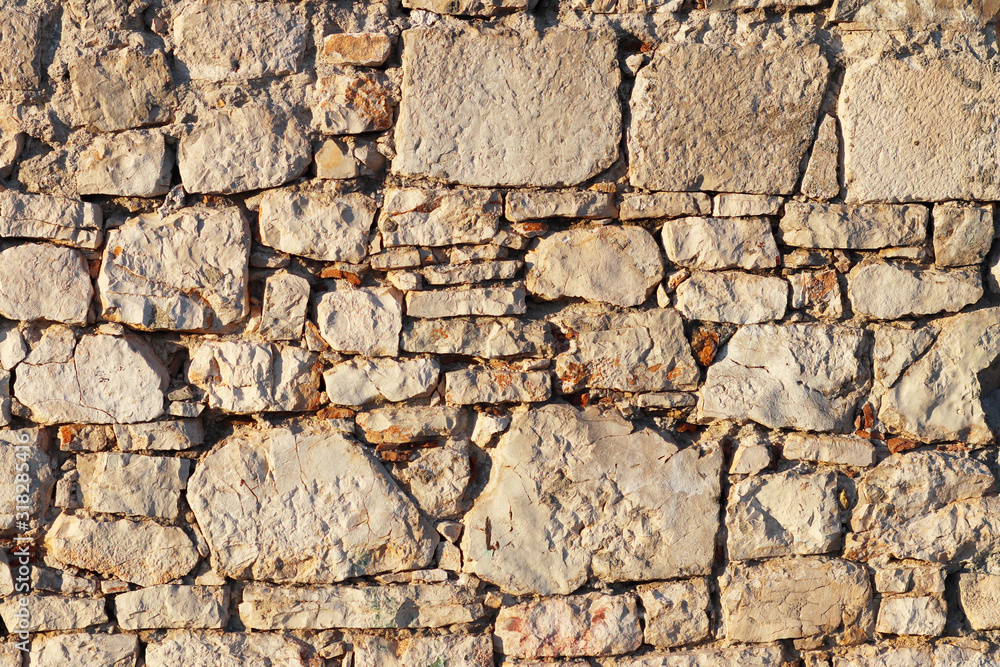 Ancient medieval stone masonry. Texture of a fragment of a wall of an old structure. A background for design and creative work. Decoration and exterior decoration of the building. Construction works Ancient medieval stone masonry. Texture of a fragment of a wall of an old structure. A background for design and creative work. Decoration and exterior decoration of the building. Construction works