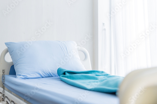 The patient blue bed with bed sheet in the hospital.