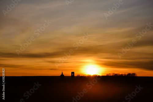 silhouette of church on a sunset background, an abandoned church in field at sunset, church on colorful sunset sky