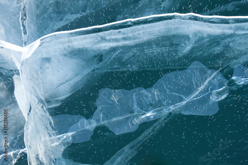 Cracks in turquoise ice of Baikal lake
