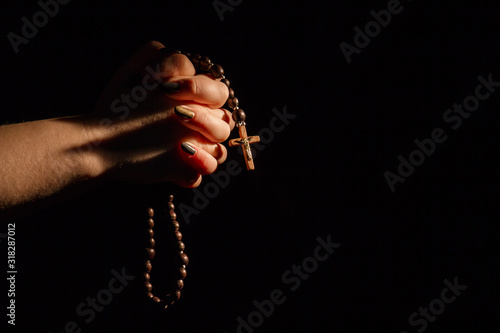 Fototapeta Female hands praying to God with rosary and wooden cross