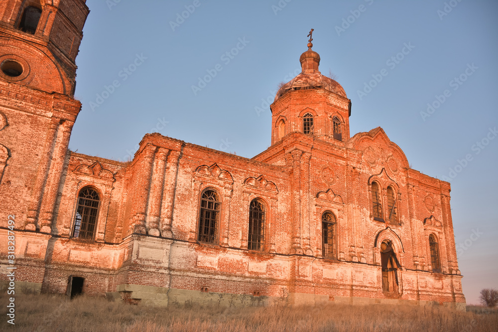 An ancient abandoned and ruined Church, crumbling red brick temple, An abandoned red brick temple illuminated by sunset sun, an abandoned church at sunset