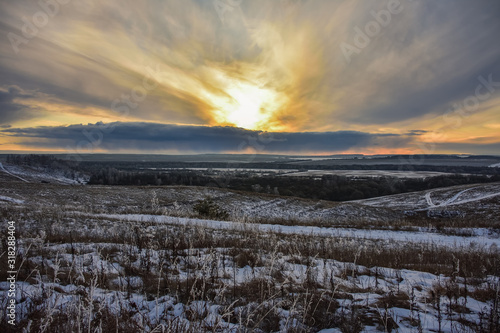 Colorful sunset in the field  winter sunset  orange bright sunset in the winter field