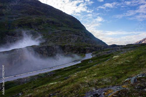 Mountain view and blue sky in the morning in Norway. Fog on the road © saharovvv