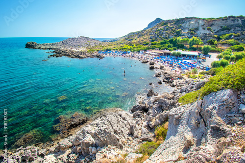 View of Ladiko beach with sun beds and sun shades (Rhodes, Greece)