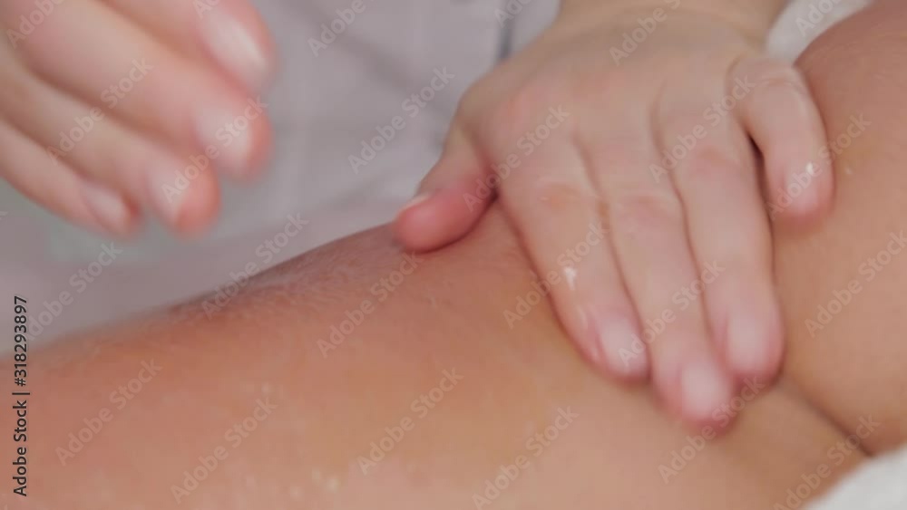 Woman massage therapist makes honey massage to a young girl in a massage parlor. Woman massage therapist makes honey massage to a young girl in a massage parlor.