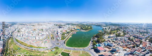 Aerial view of Da Lat city beautiful tourism destination in central highlands Vietnam. Clear blue sky. Urban development texture, green parks and city lake. photo
