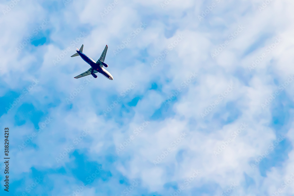 Passenger plane flying in blue sky with white clouds Passenger plane flying in blue sky with white clouds