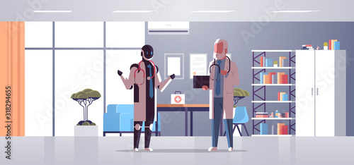 robot and human doctors discussing during meeting robotic character vs man standing together healthcare artificial intelligence technology concept hospital office interior full length horizontal