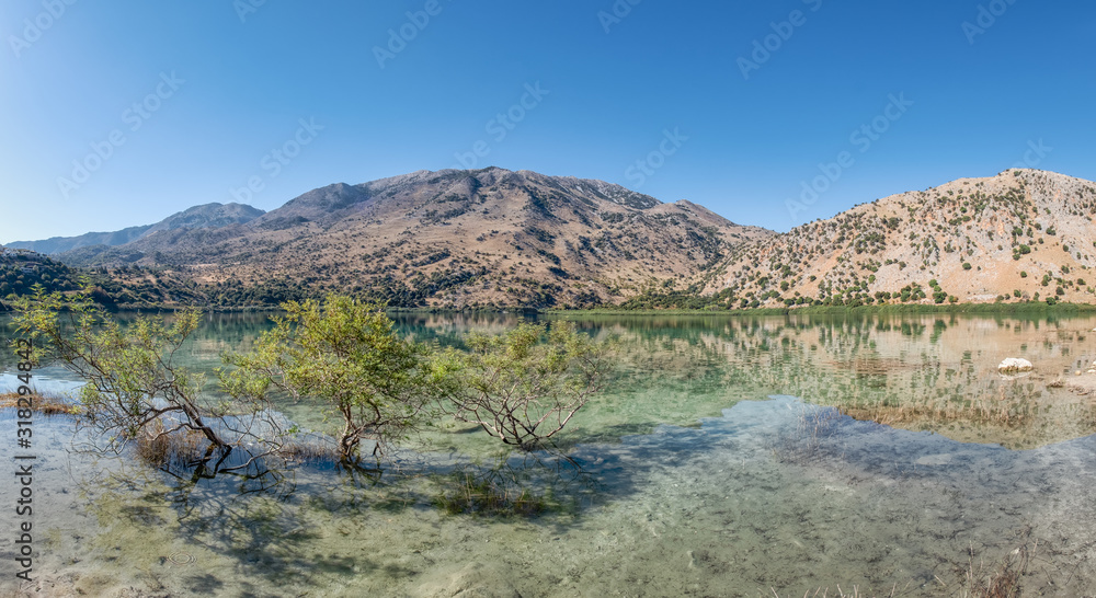 Panorama of natural freshwater lake Kournas near Georgioupolis, the White Mountains reflected in the water, Crete, Greece