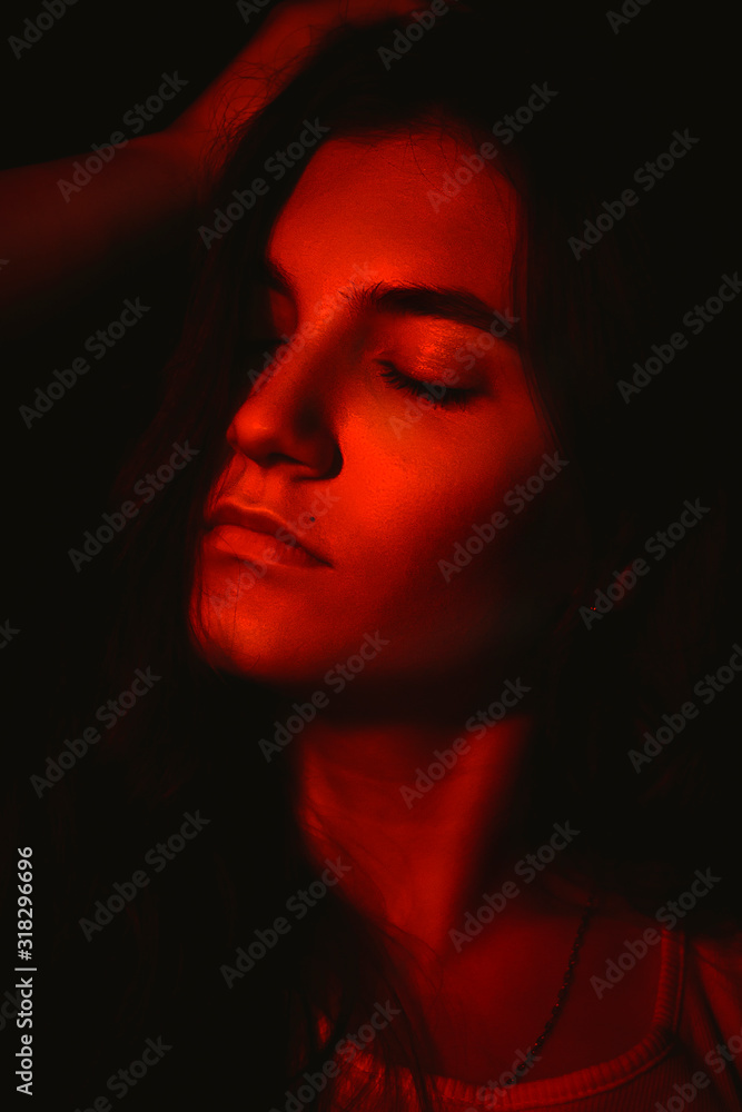 dark portrait of a girl in red light dark portrait of a girl in red light