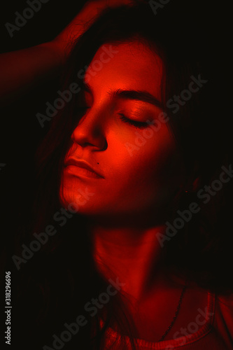 dark portrait of a girl in red light