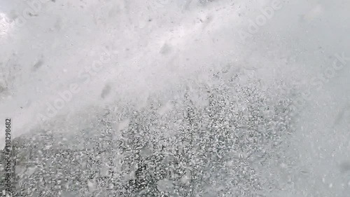 Powerful jet of foam under pressure. Background of splashing white foam.