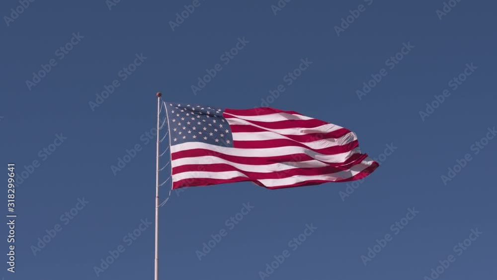 American flag is waving on blue sky background American flag is waving on blue sky background