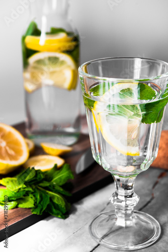 Fresh lemonade with mint in a glass jug on a white background