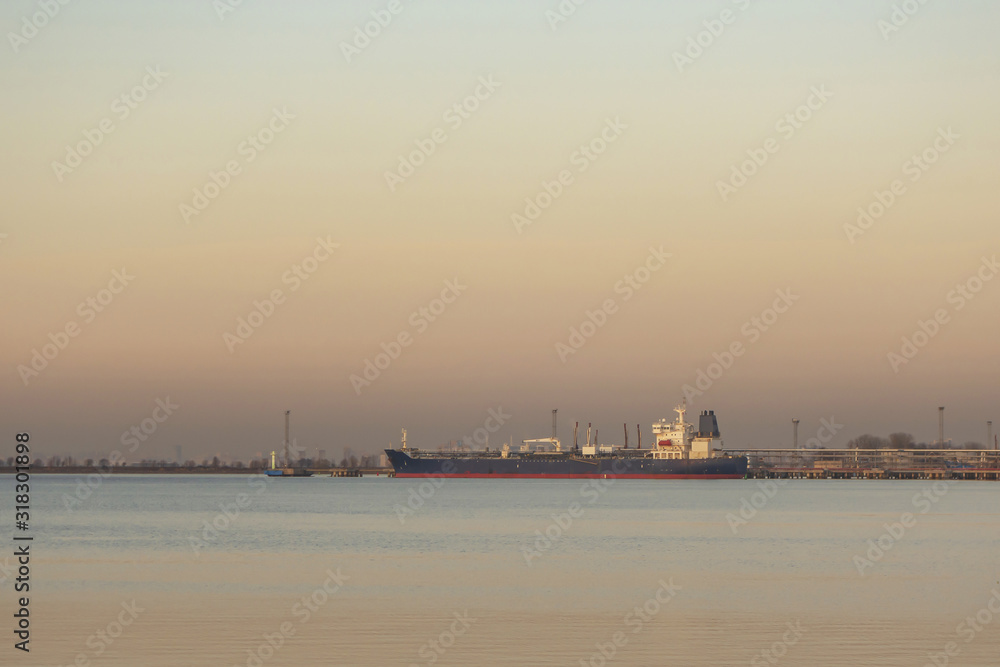 Cargo ship at the pier at sunset