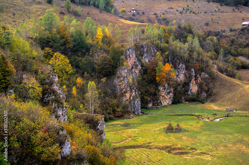 Autumn colors in a cliff wall. Beautiful autumn scenery of Ponor Valley with colorful foliage.