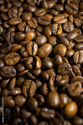 Dark background and texture of coffee beans  selective focus  closeup grains.