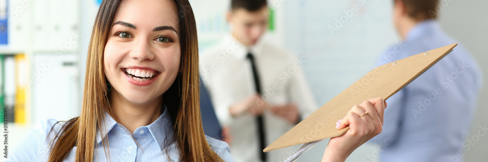 Portrait of happy woman working with smart colleagues in big modern building and participating in intense brainstorming process. Company meeting concept Portrait of happy woman working with smart colleagues in big modern building and participating in intense brainstorming process. Company meeting concept