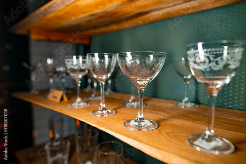 Professional bartender equipment as different transparent white ornate glasses